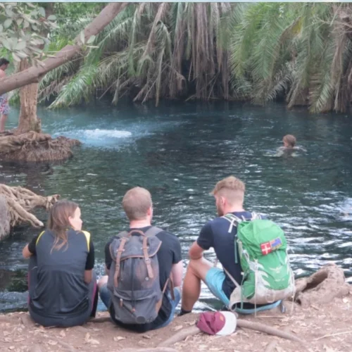 Chemka kikuletwa hot springs visitors relaxing in clear blue water tanzania