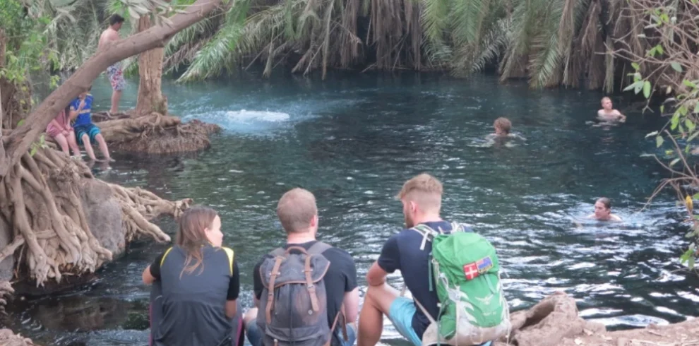 Chemka kikuletwa hot springs visitors relaxing in clear blue water tanzania