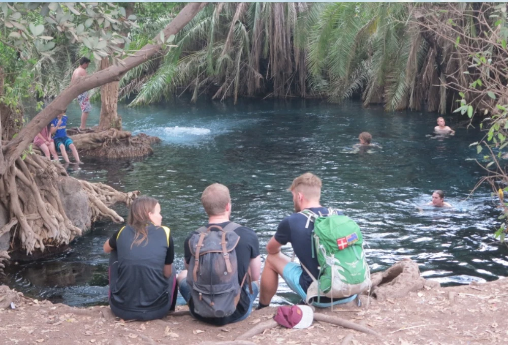Chemka kikuletwa hot springs visitors relaxing in clear blue water tanzania