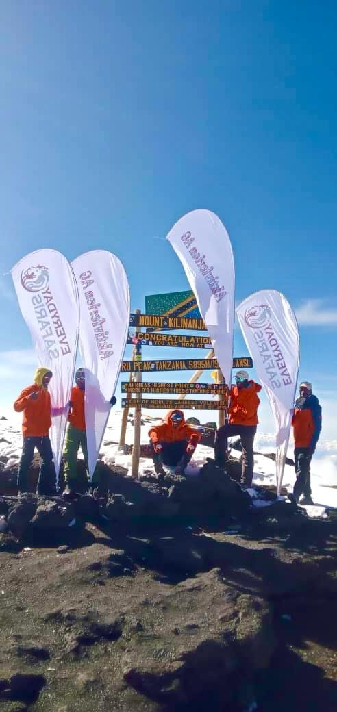Everyday Safaris mountain team at Uhuru Peak summit on Mount Kilimanjaro in Tanzania