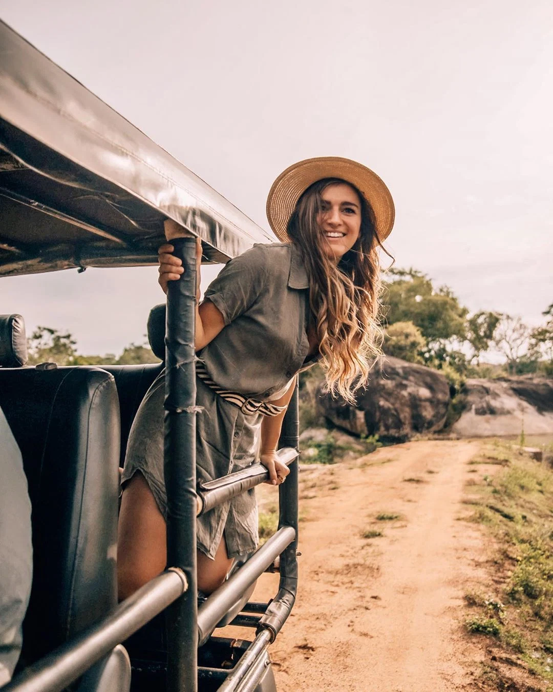 Wildlife photographer observing an elephant from a private safari vehicle