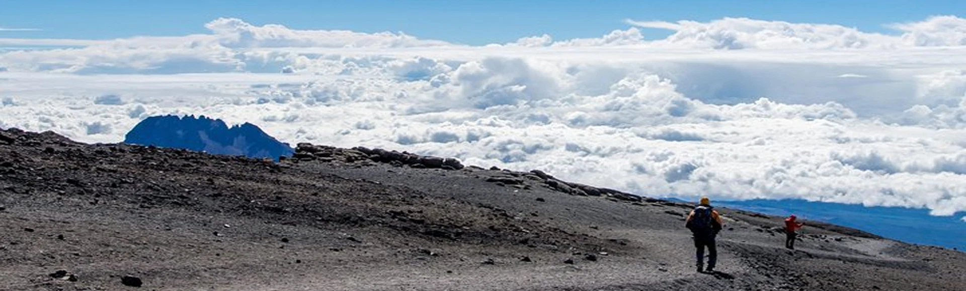 Kilimanjaro day hike across high altitude alpine desert above clouds