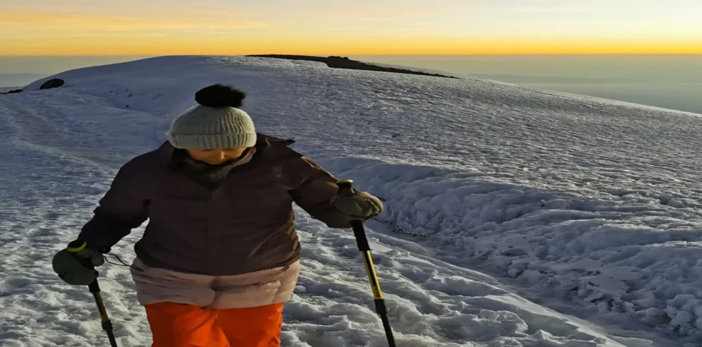 Kilimanjaro lemosho route climber crossing snowy high altitude ridge