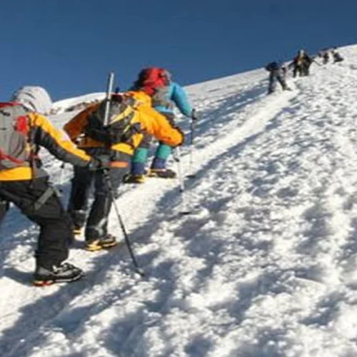 Kilimanjaro northern circuit climbers crossing snow covered high altitude ridge