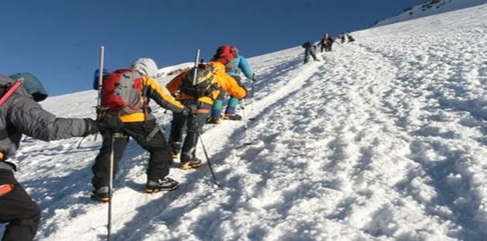 Kilimanjaro northern circuit climbers crossing snow covered high altitude ridge