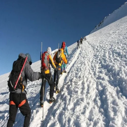 Kilimanjaro northern circuit climbers crossing snow covered high altitude slope