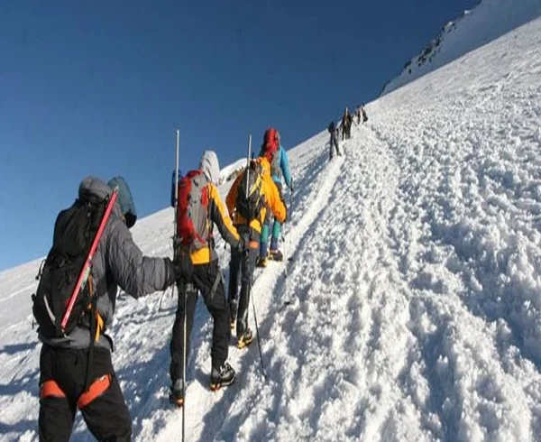 Kilimanjaro northern circuit climbers crossing snow covered high altitude slope