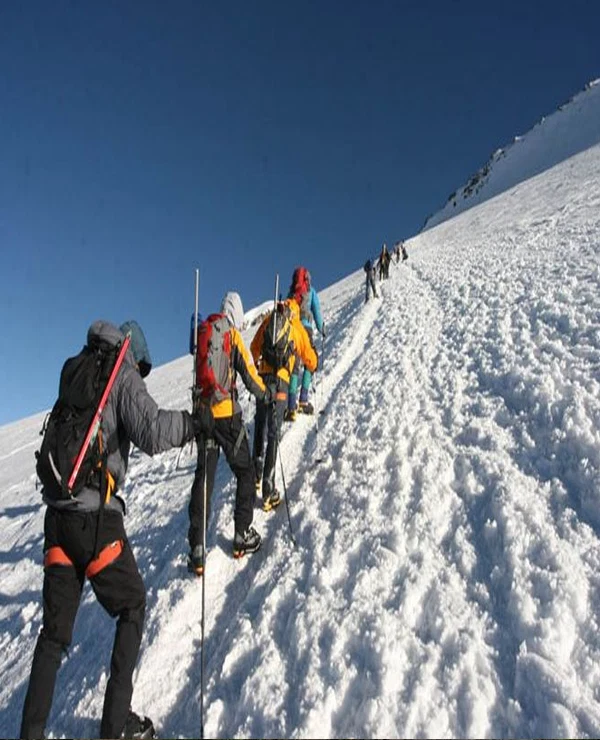 Kilimanjaro northern circuit climbers crossing snow covered high altitude slope