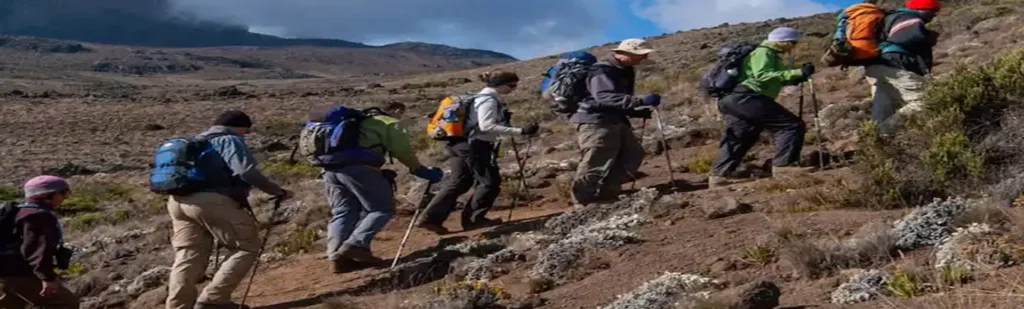 Kilimanjaro umbwe route climbers ascending steep rocky mountain trail tanzania