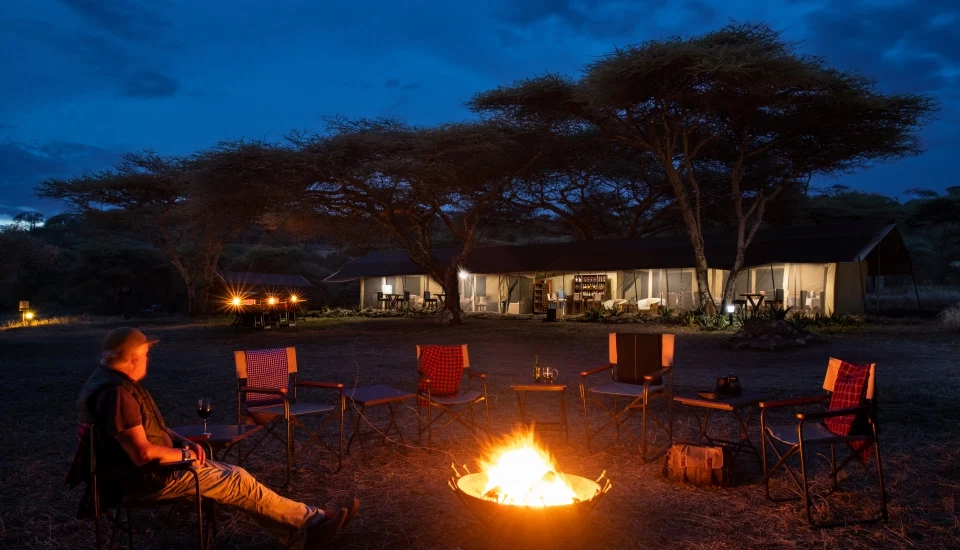 Luxury tented safari camp fireplace and evening lounge tanzania
