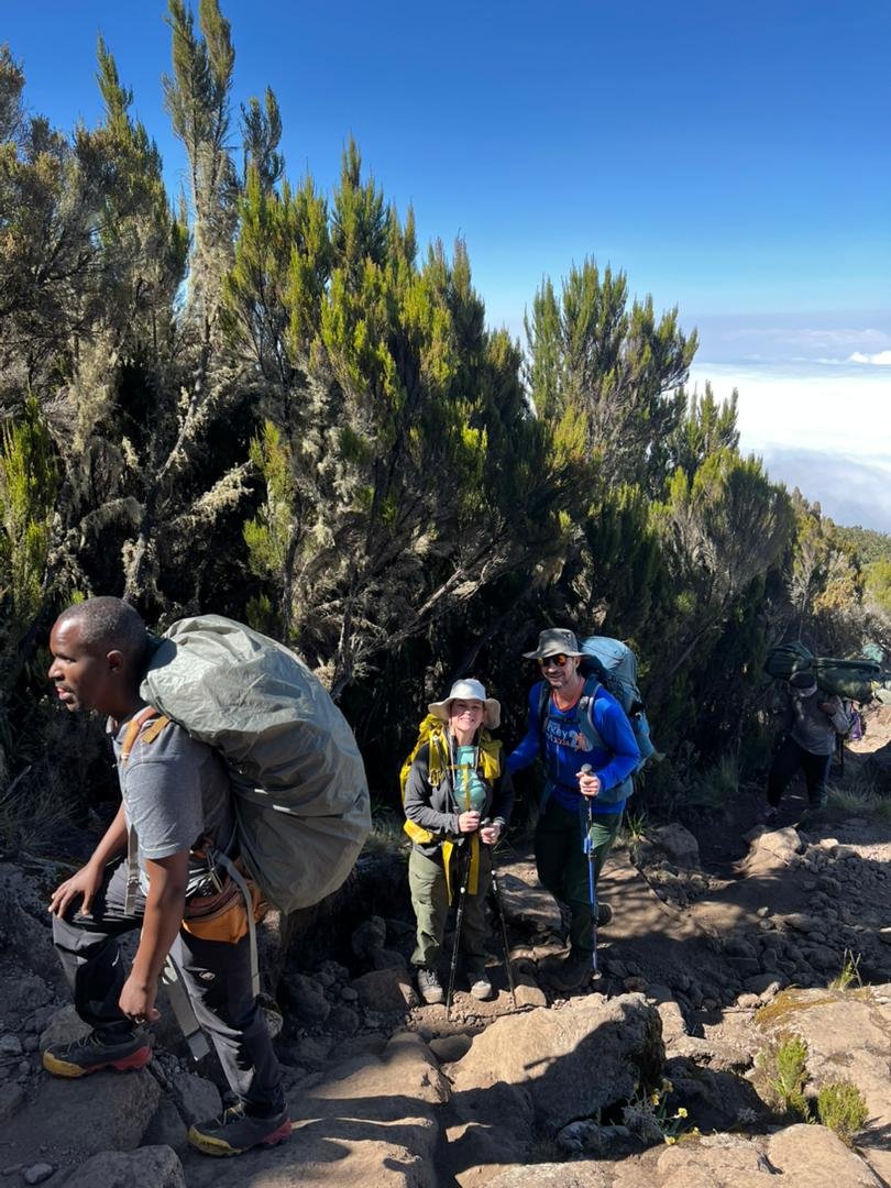 Machame Route Kilimanjaro climbers ascending moorland trail in Tanzania