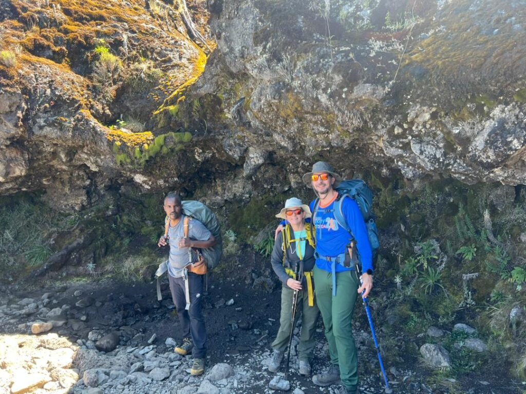 Machame day hike Kilimanjaro trekkers rest stop volcanic rock