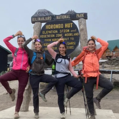 Mount meru climbers at saddle hut route sign in arusha national park