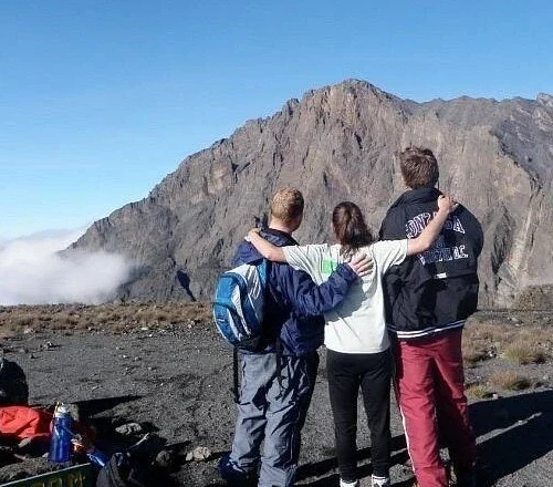 Mount meru climbers looking across rugged volcanic summit ridge tanzania