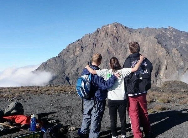 Mount meru climbers looking across rugged volcanic summit ridge tanzania