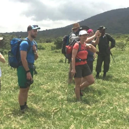 Mount meru trekkers crossing highland grassland on momella route tanzania