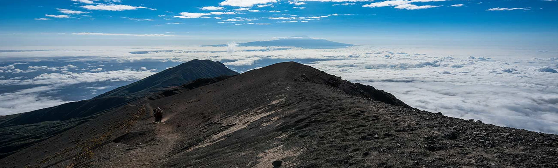Mount Meru trekker with Kilimanjaro view