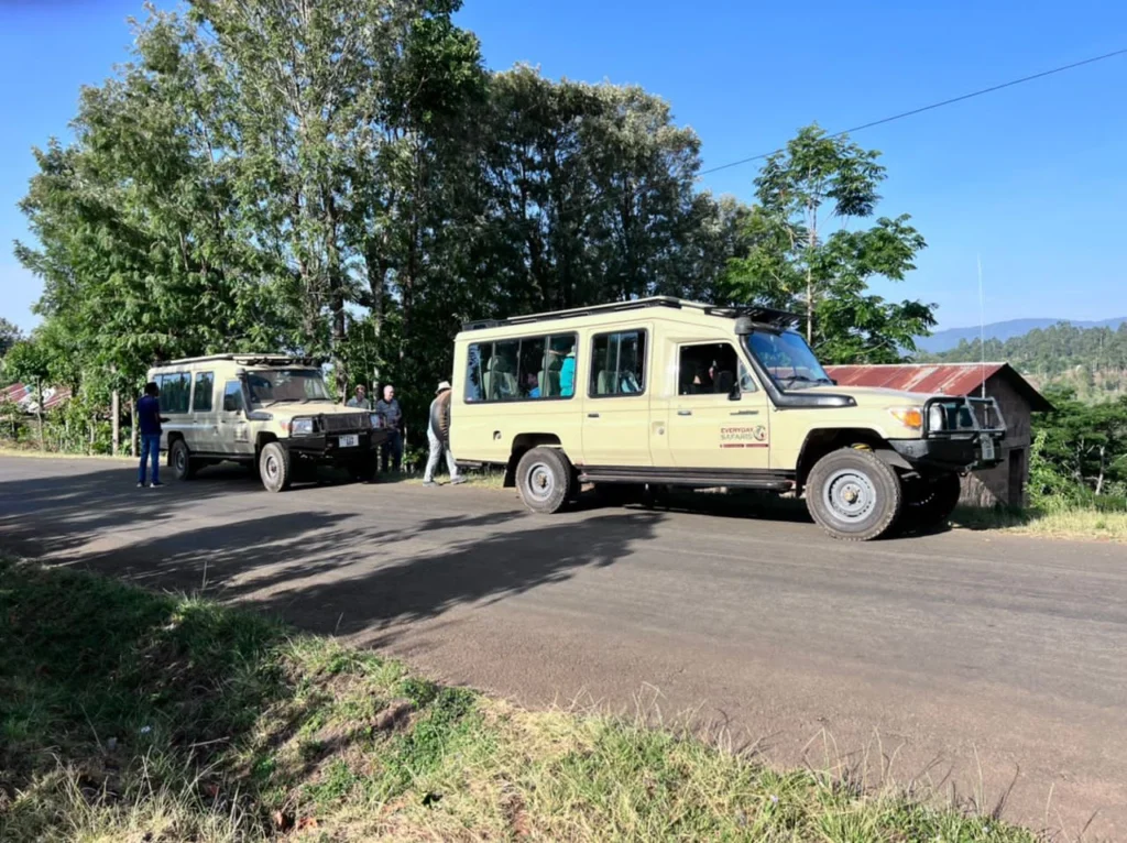 Tanzania Safari Four Wheel Drive Vehicles On Road Near Wildlife Park 1