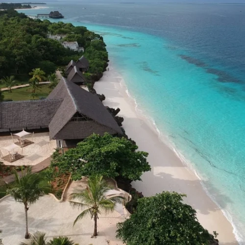 Aerial view of a luxury Zanzibar beachfront resort beside white sand and turquoise water