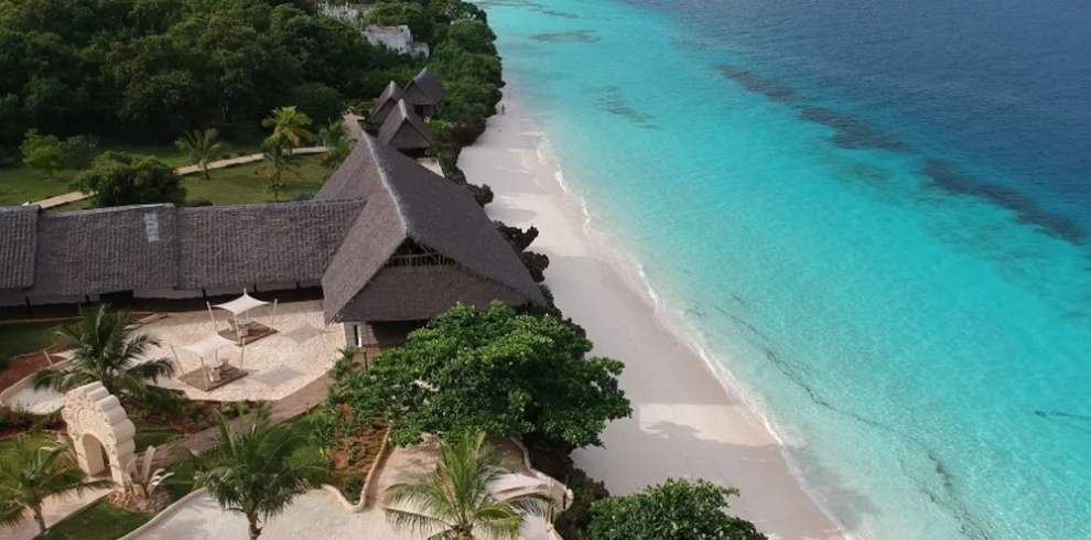 Aerial view of a luxury Zanzibar beachfront resort beside white sand and turquoise water