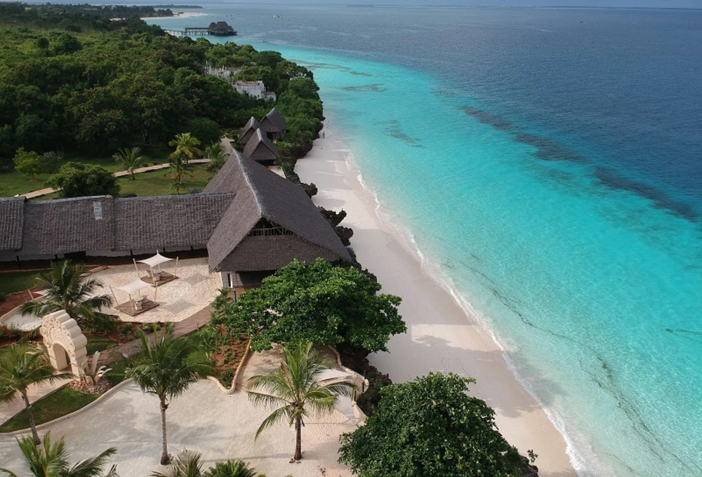 Aerial view of a luxury Zanzibar beachfront resort beside white sand and turquoise water