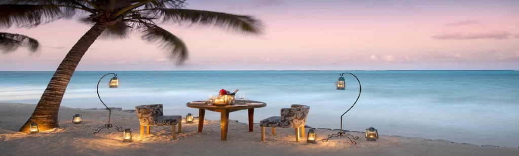 Romantic Zanzibar beach dinner at sunset beside the Indian Ocean