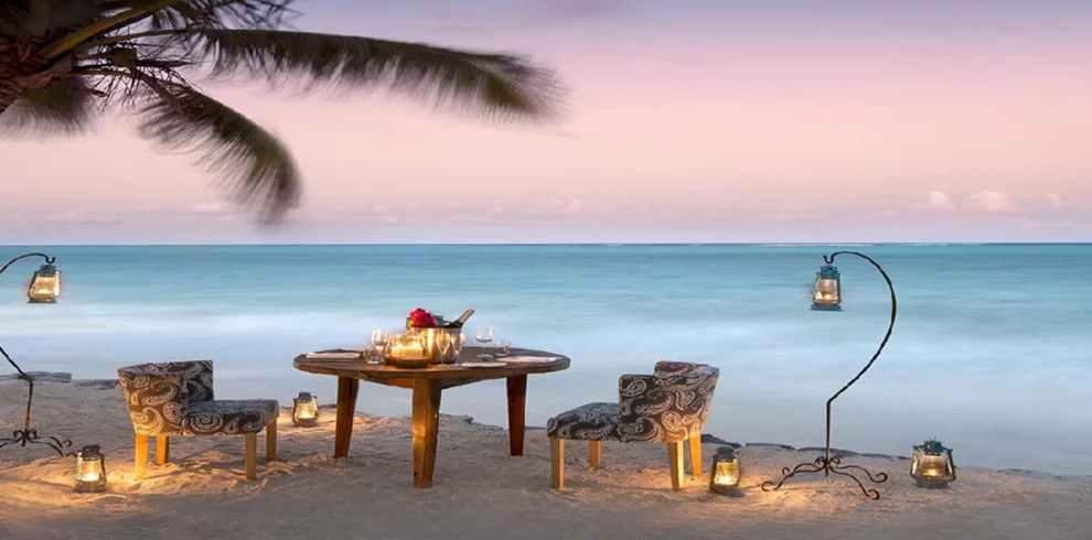 Romantic Zanzibar beach dinner at sunset beside the Indian Ocean